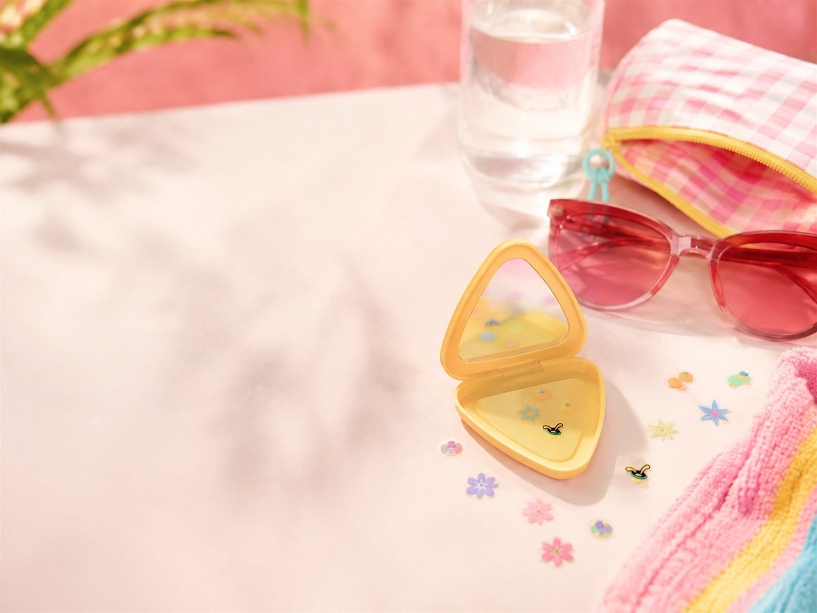 SHANLE LAB pimple patches, mirror case, and bracelet arranged in a summer bag